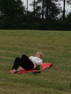 Ann stretches her muscles and loosens her joints with a foam roll session on the grass of an interstate rest area. Needless to say, the attendants were captivated.